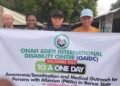 Persons with Albinism holding an event flex banner along with Mr Onah