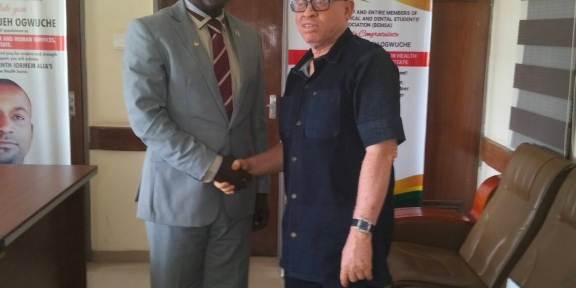 Picture of Dr. Paul Ogwuche and Adeyi Onah Daniel shaking hands