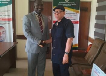 Picture of Dr. Paul Ogwuche and Adeyi Onah Daniel shaking hands